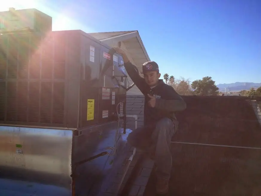 HVAC technician performing HVAC Inspection on a rooftop unit in Marble Falls